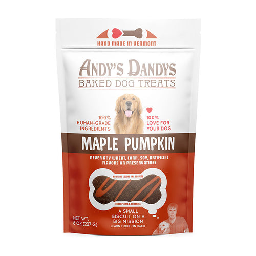 Front of white and orange pouch of tasty Andy’s Dandys Maple Pumpkin flavor mini bone shaped baked dog biscuits drizzled with orange yogurt icing