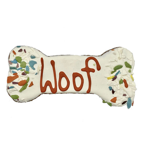 One Andy's Dandys Honey Oat flavor large bone shaped baked dog biscuit fully dipped in white yogurt icing with yogurt sprinkles and woof design